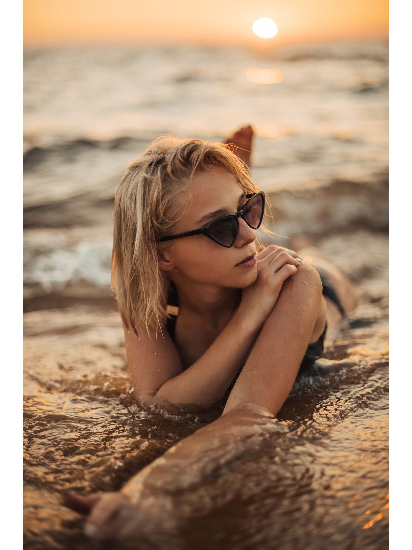 Woman wearing cat-eye sunglasses at golden hour